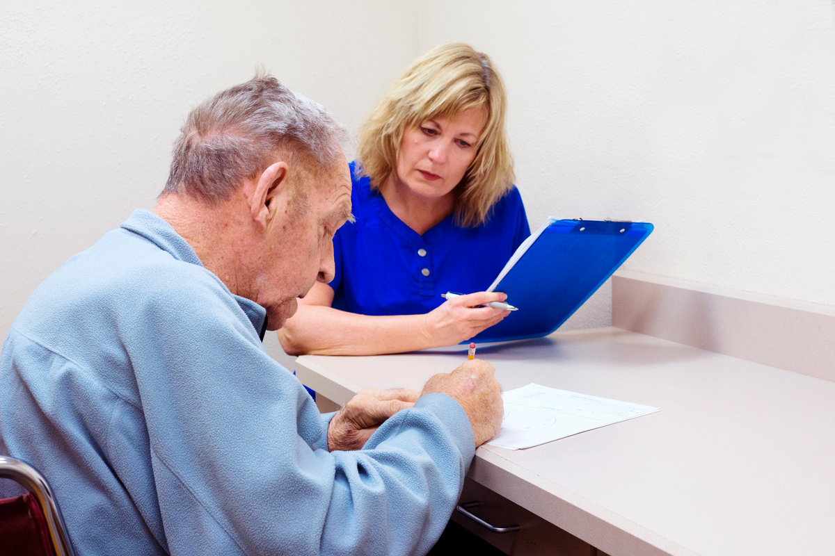 Senior man taking cognitive test in speech therapy session